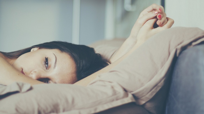 Woman with painted nails lying down