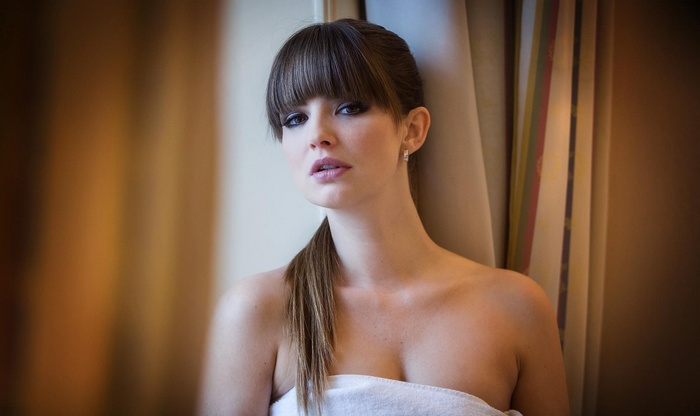 Woman with bangs wearing a white towel