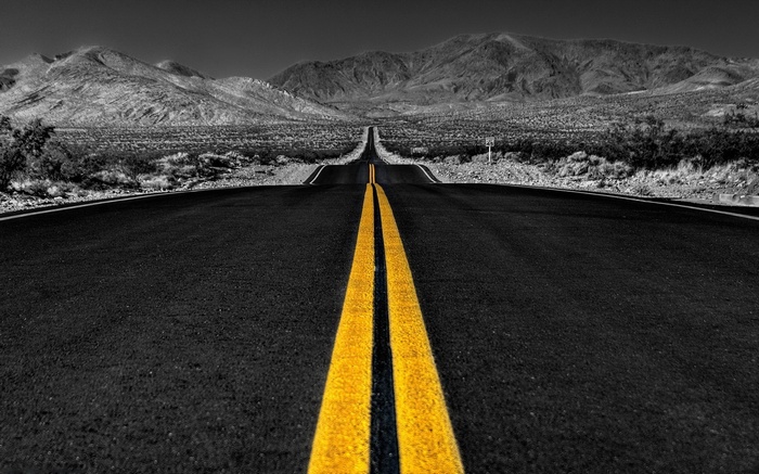 Desert road with mountains and selective coloring