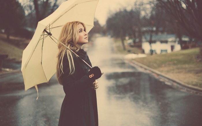 Woman with umbrella in the rain on a street