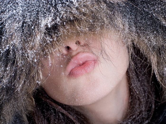 Close-up of a woman's face covered in snow