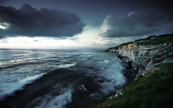 Dramatic sea cliffs under a stormy sky