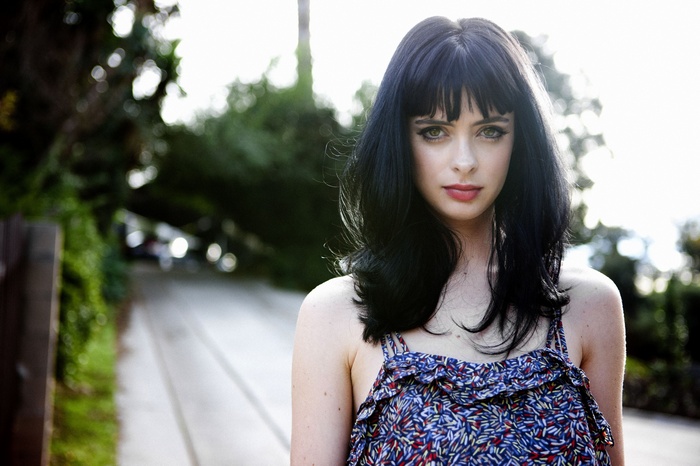 Krysten Ritter in a floral dress outdoors