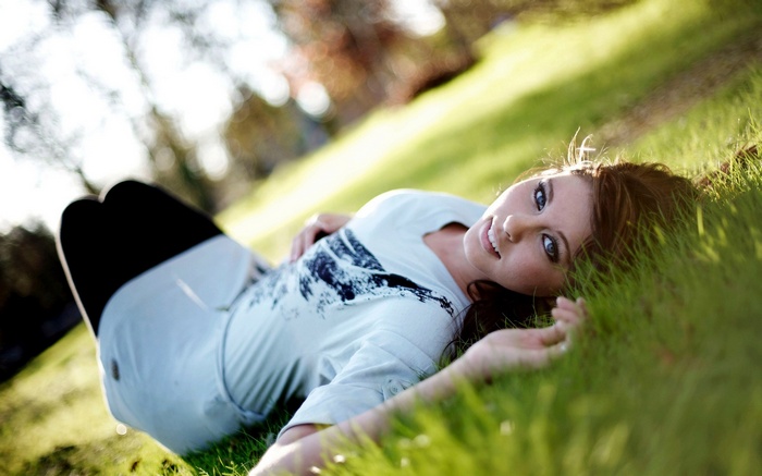 Woman lying on grass outdoors