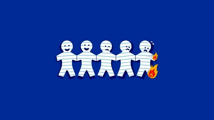 Paper people chain with one on fire