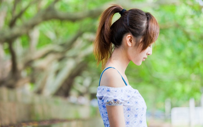 Asian woman with ponytail in profile