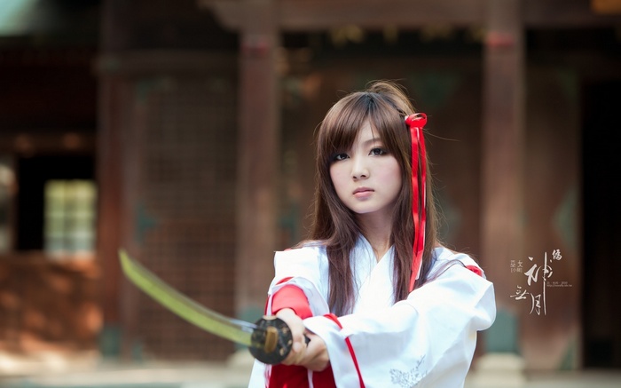 Woman in white and red holding a sword