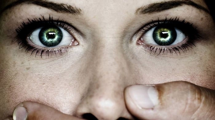 Susan Coffey's green eyes covered by a hand
