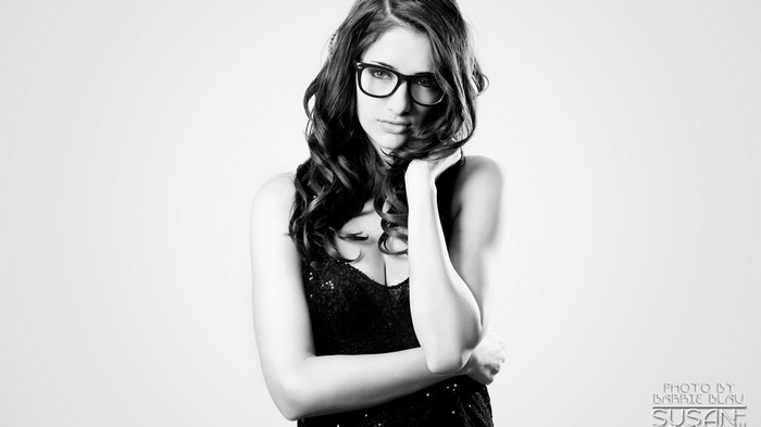 Susan Coffey wearing glasses and a sequined dress