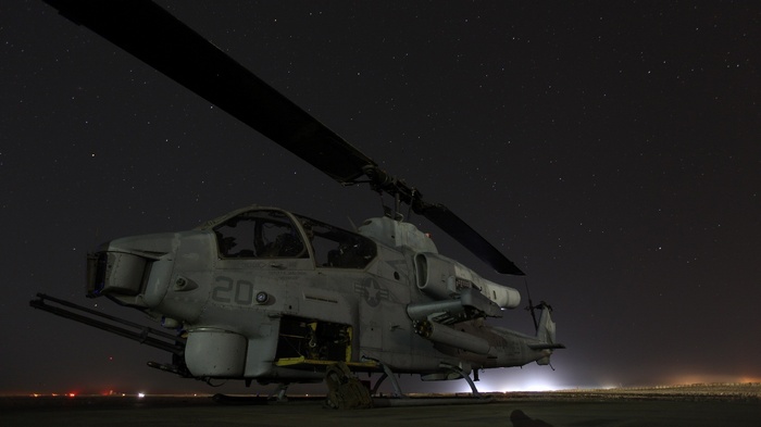 AH-1W SuperCobra helicopter under a starry night sky