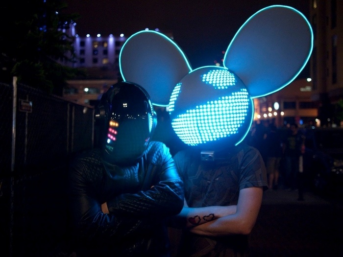 Two DJs wearing LED masks at night