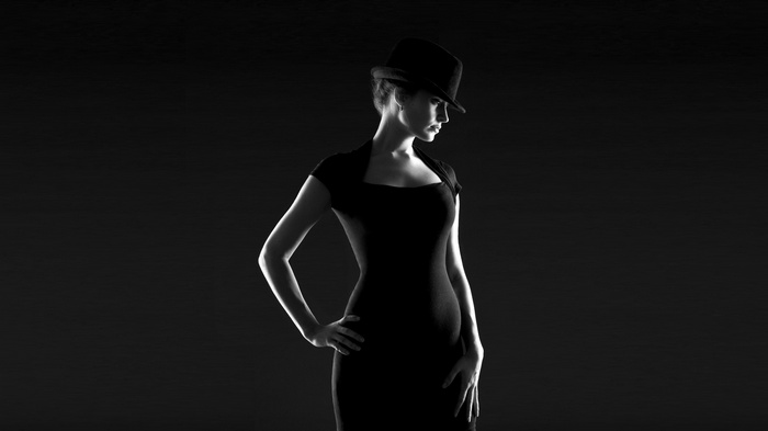 Woman in black dress and hat