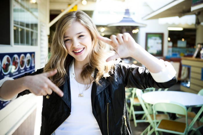Chloë Grace Moretz smiling outdoors