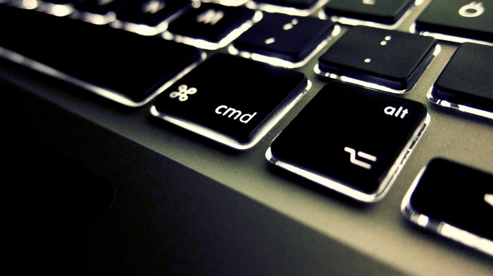 Close-up of Apple MacBook keyboard with illuminated keys