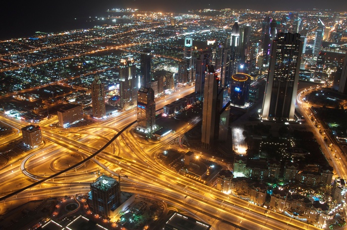 Dubai cityscape at night with illuminated highways and skyscrapers