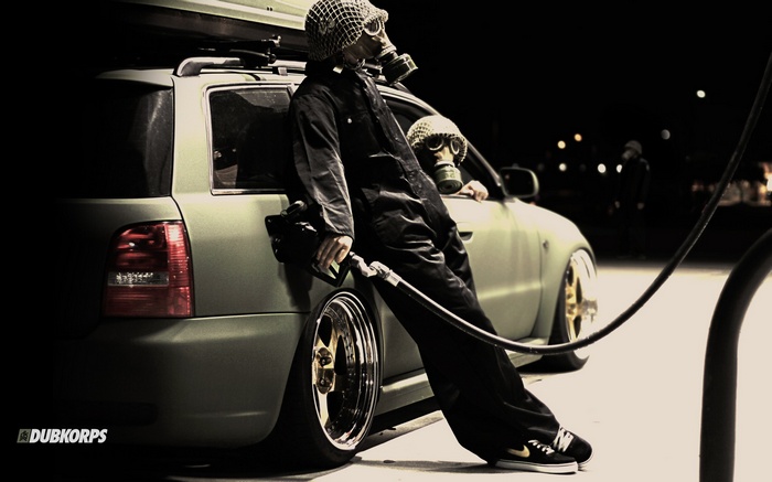 Audi A4 with people in gas masks at a gas station