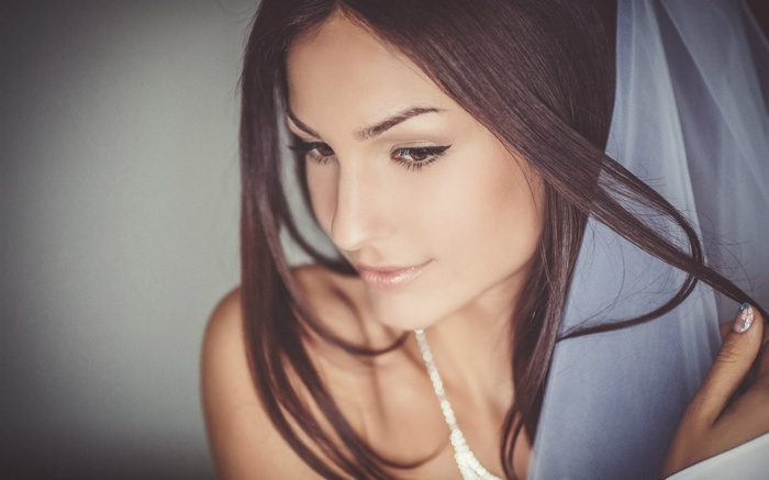 Woman with dark hair and veil