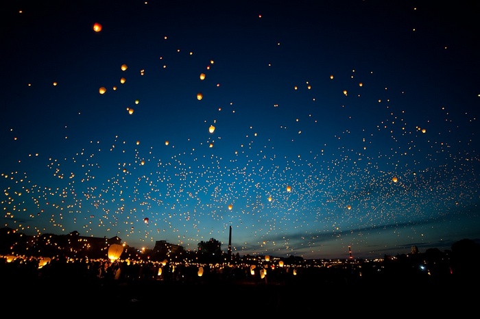 Thousands of sky lanterns float in the night sky