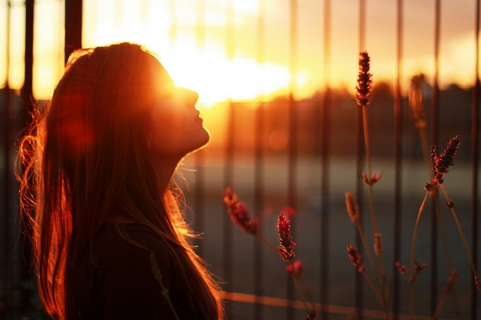 Woman bathed in golden sunset light