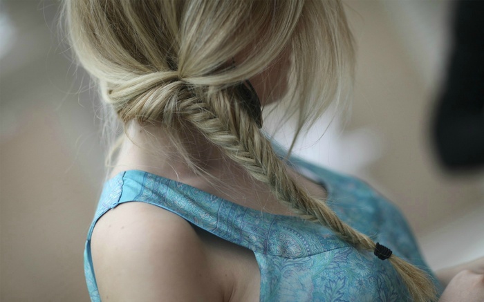 Woman with blonde hair in a fishtail braid