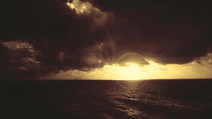 Sunset over the sea with lens flare