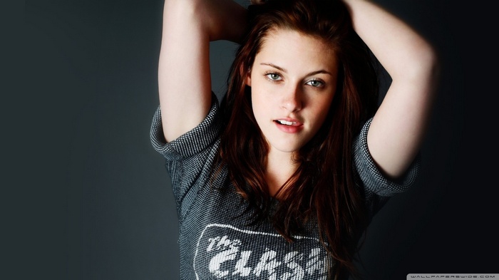 Kristen Stewart with arms up wearing a t-shirt