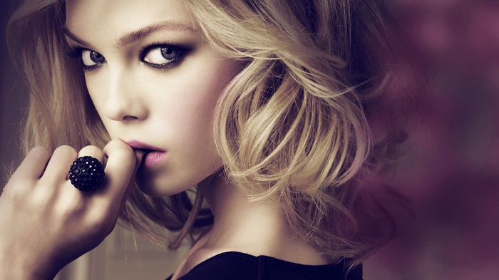 Woman with blonde hair and dark makeup wearing a ring