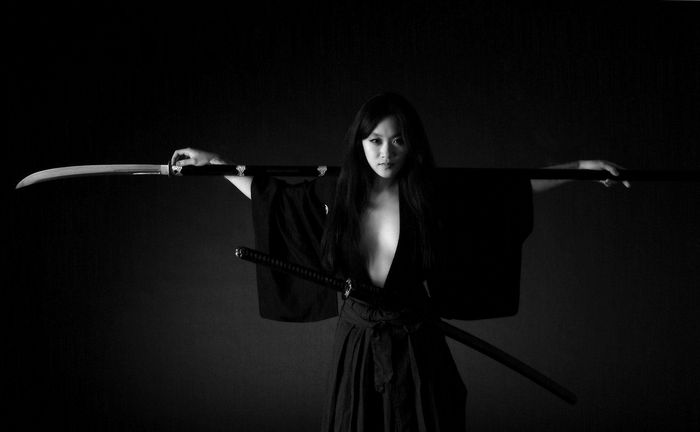 Woman in kimono holding two katanas