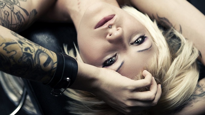Blonde woman with tattoos and piercing