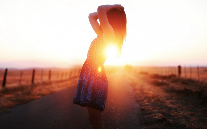 Woman in dress at sunset on a path