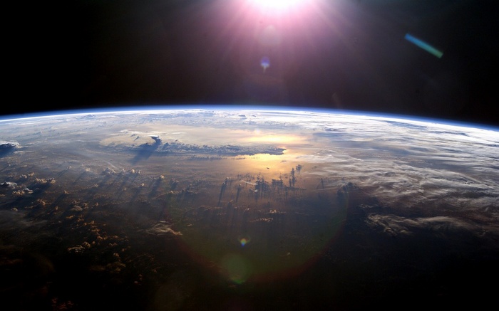 Earth from space with sun glare