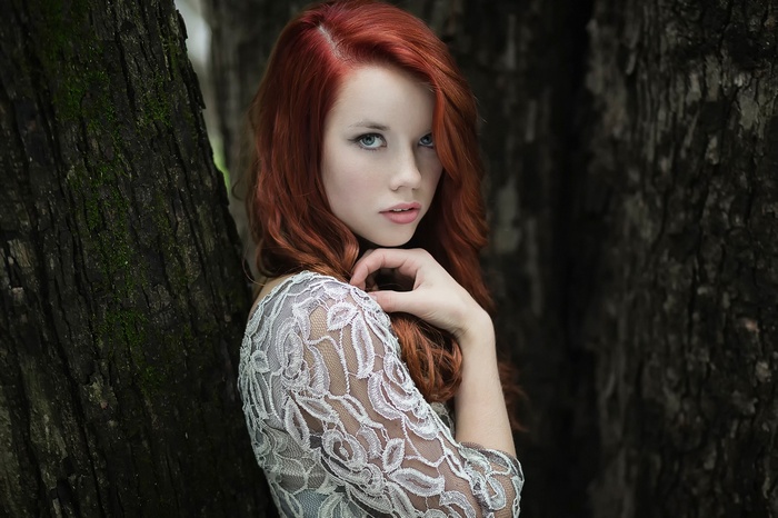 Redhead woman with long hair in a lace dress