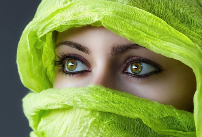 Woman with green eyes wearing a green veil