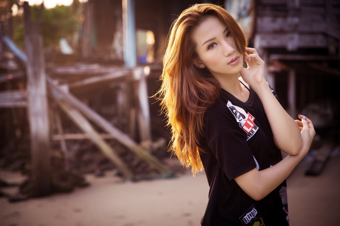 Asian woman with long auburn hair in a black shirt