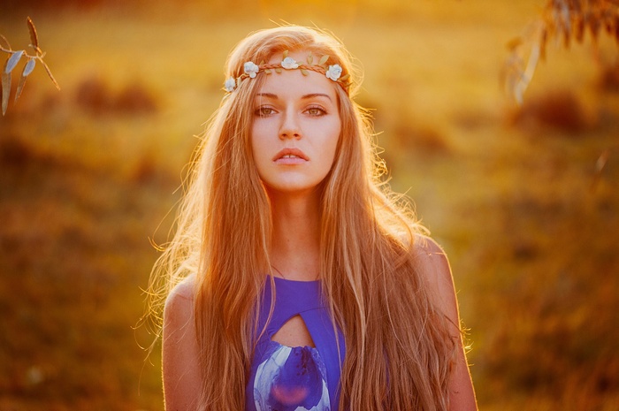 Woman with blonde hair and flower crown outdoors