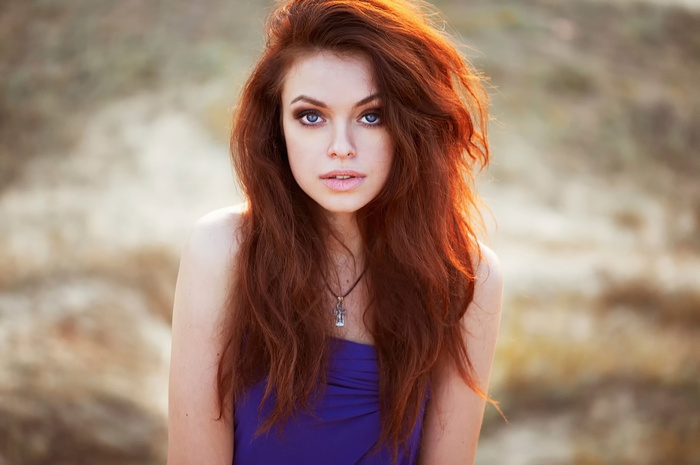 Redhead woman with blue eyes and necklace