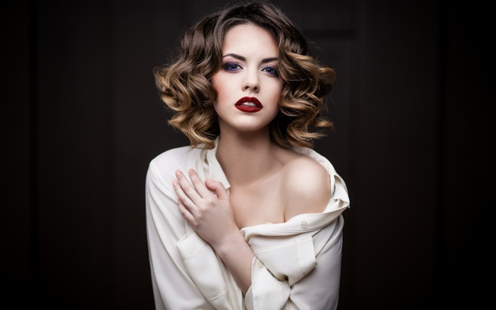 Woman with curly hair and red lipstick