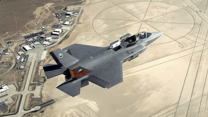Lockheed Martin F-35 Lightning II flies over a military base