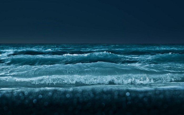 Dark ocean waves under a night sky
