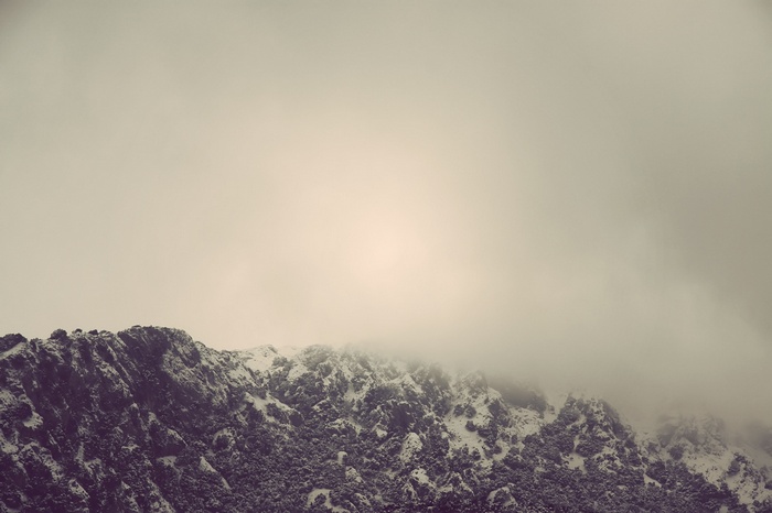 Snow-covered mountains shrouded in mist