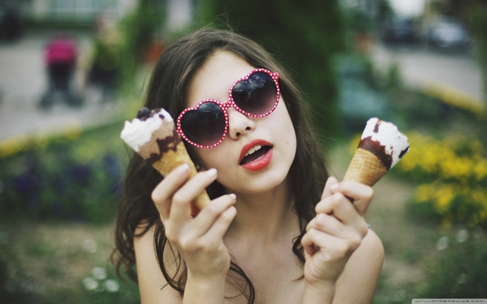 Girl with heart sunglasses eating ice cream