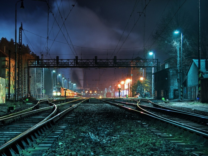 Train at a railway crossing at night