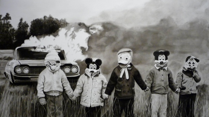 Children in masks by burning car