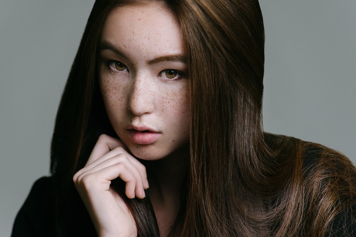 Young Asian woman with freckles and brunette hair