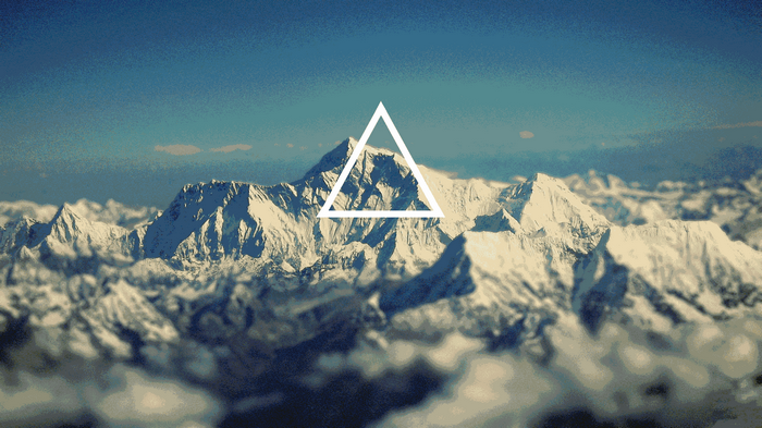 White triangle over snow-capped mountains