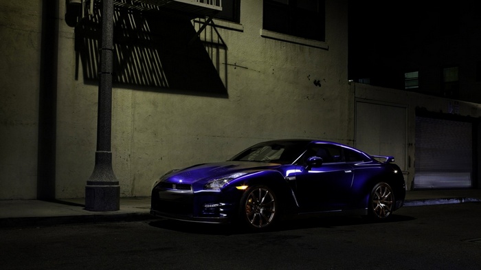 Blue Nissan GT-R parked at night