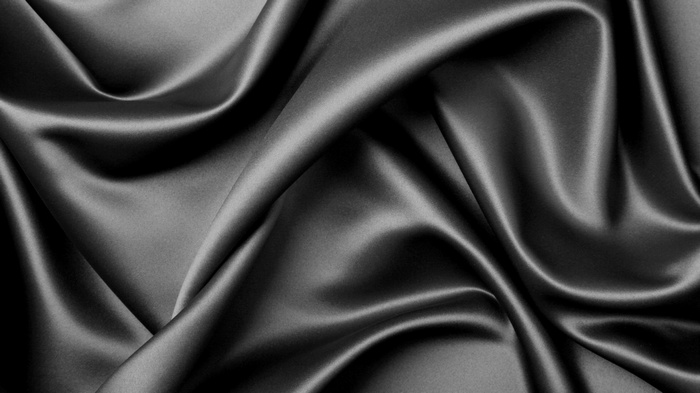 Black satin fabric texture with folds