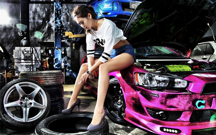 Asian woman sitting on a pink Mitsubishi car