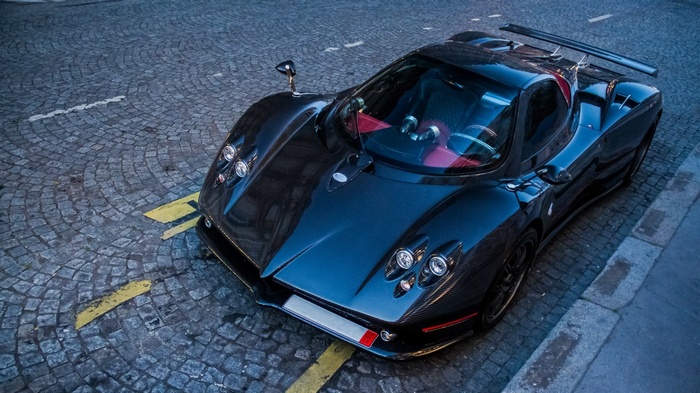 Black Pagani Zonda R supercar on cobblestone street