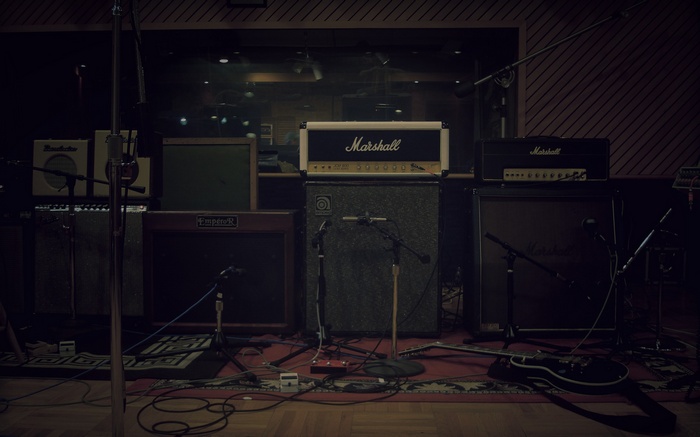 Marshall and Fender guitar amplifiers in a studio